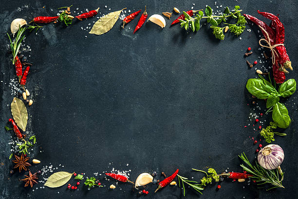 istock Herbs and spices over black stone background 542308086