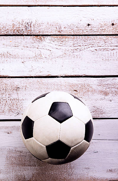 istock Soccer ball against wooden background. Studio shot. Copy space. 542309228