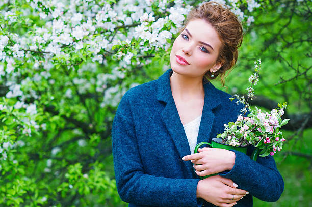 istock Woman in blooming spring garden 542310256