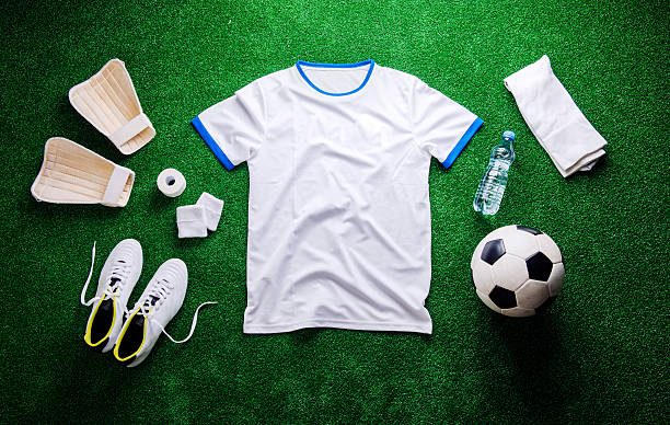 istock Soccer ball,cleats and various football stuff against artificial 542311036