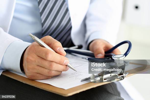 Male Medicine Doctor Hand Holding Silver Pen Writing Stockfoto en meer beelden van Dokter