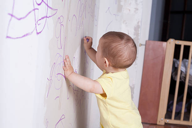 istock Baby boy drawing and safety gate 542312066