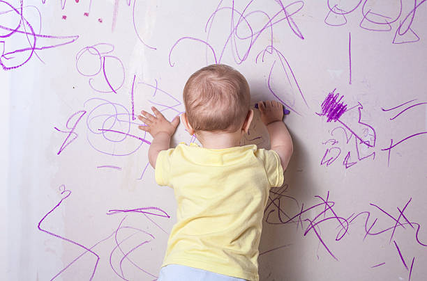 istock Baby boy drawing on plasterboard wall 542312344