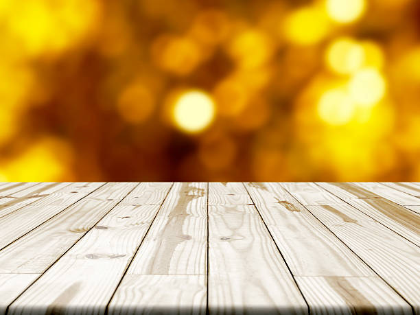 istock Wood table and blurry orange in background. 542313454