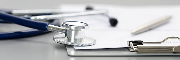 istock Stethoscope head lying on medical form on clipboard pad 542314502
