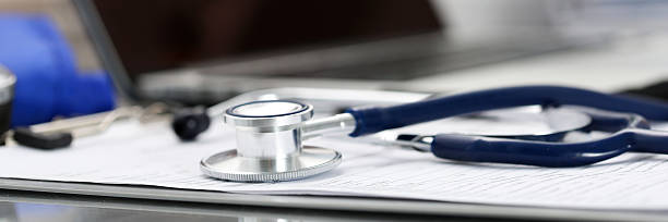 istock Stethoscope head lying on medical form on clipboard pad 542314650