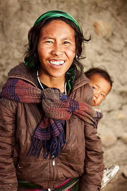 istock Young Tibetan mother carrying her child 542314870