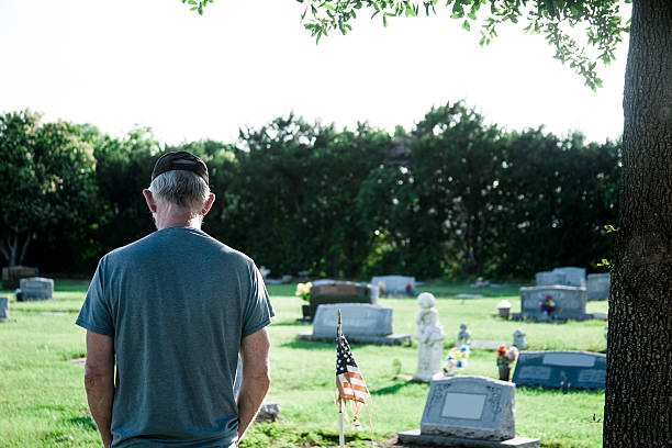 istock Sad widower, senior adult man visits cemetery. 542315058