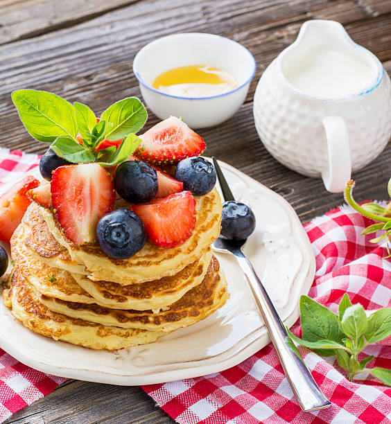 istock Delicious pancakes with berries on wooden background 542316152