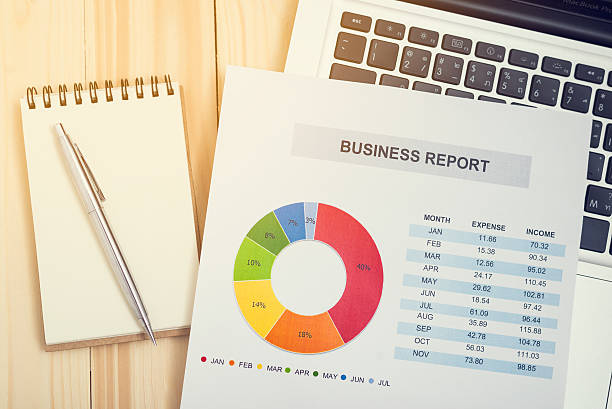 istock Financial report with laptop on wooden table 542316640