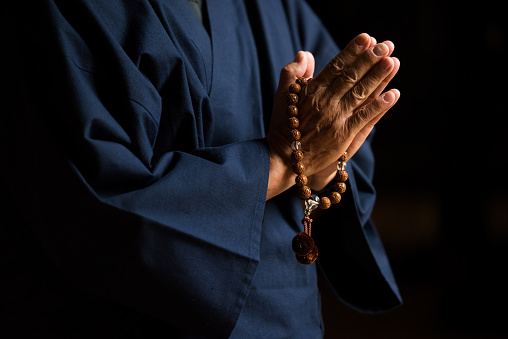 Senior hands with prayer beads