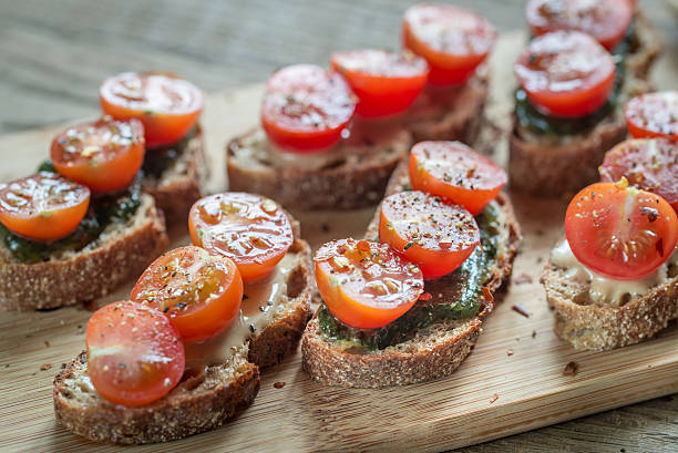 istock Toasts with tahini and mint sauce and cherry tomatoes 542318406
