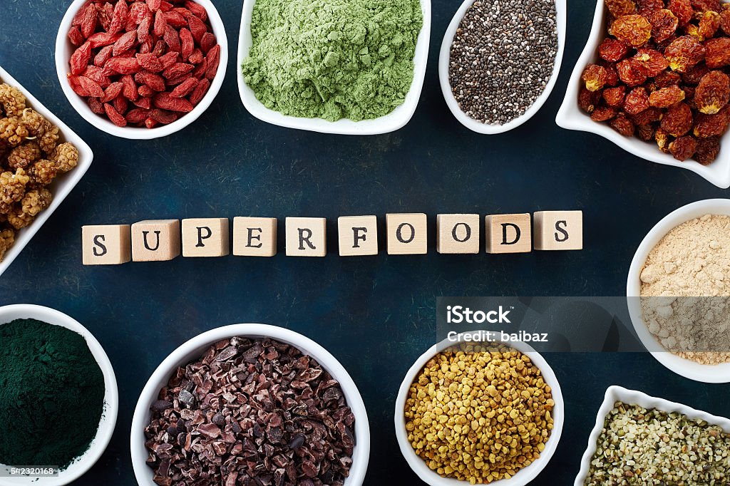 Various healthy superfoods Bowls of various superfoods on old blue background. Top view Antioxidant Stock Photo