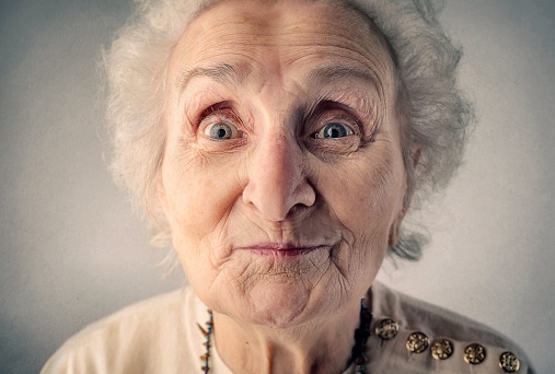 Close up portrait of a surprised little old lady 
