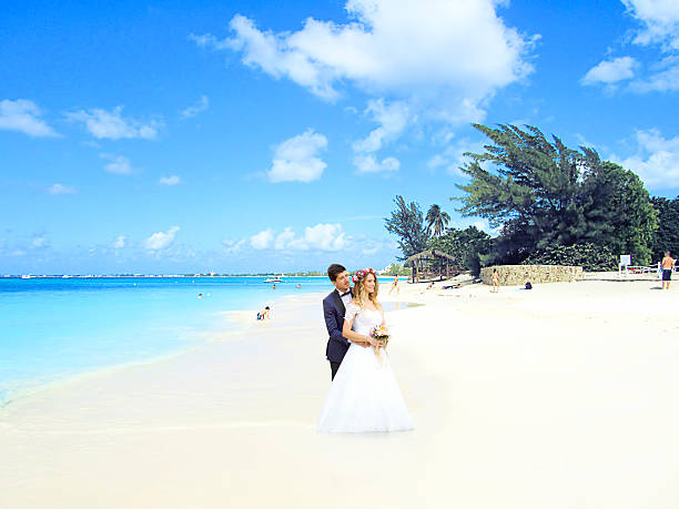 Bride in a beautiful silk dress walking toward the horizon is a half saturated dreamy effect.