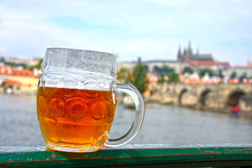 Pint of beer on the background of Prague (Czech Republic)