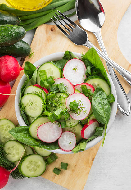 istock Salad with spinach, cucumber, radish in a bowl 542325796