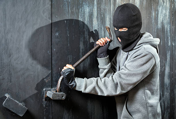 istock Burglar breaks lock on door 542326368