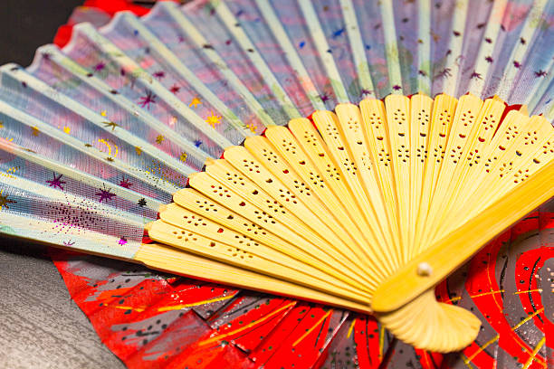 istock Japanese folding fan isolated on black background 542327370