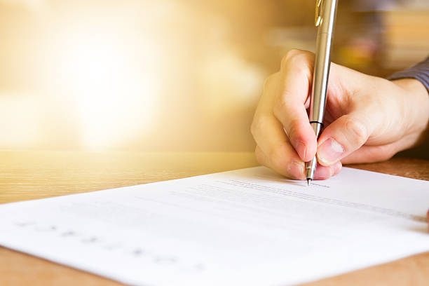 business man signing contract document stock photo