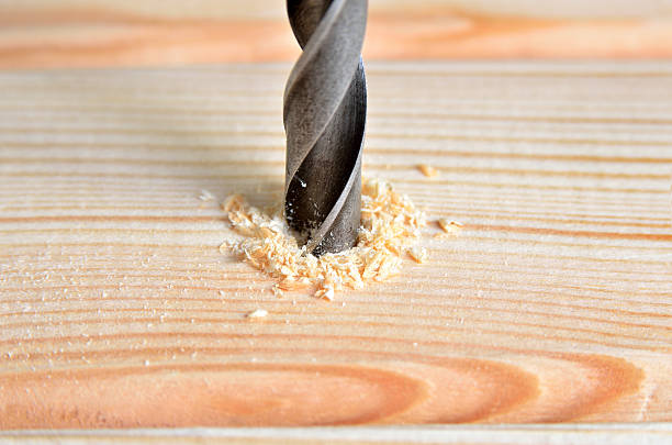 istock Steel boer drill a hole in a wooden board. 542328778