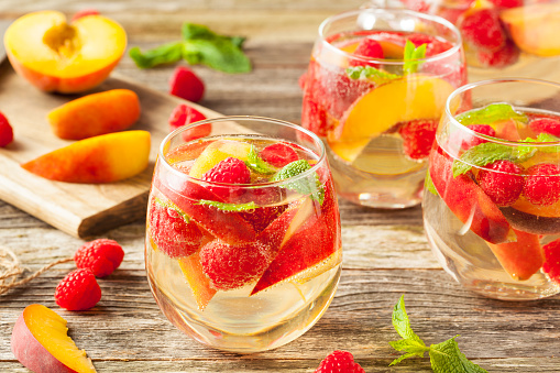 Homemade Sparkling White Wine Sangria with Peaches and Raspberries