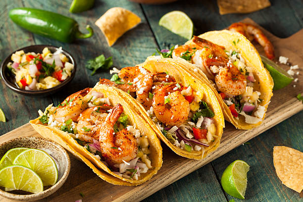 Homemade Spicy Shrimp Tacos Homemade Spicy Shrimp Tacos with Coleslaw and Salsa savory food photos stock pictures, royalty-free photos & images