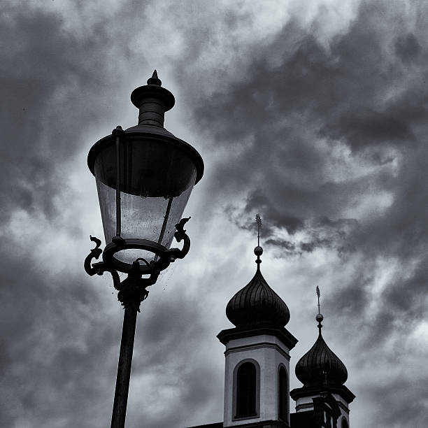 istock Street lamp and church 542331812