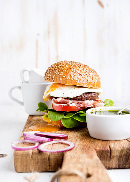 istock Breakfast set. Homemade beef burger with fried egg, vegetables, onion 542331960