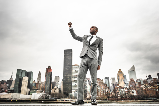 Successful business man looking away against the skyline