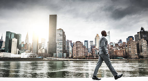 uomo d'affari di successo guardando lontano contro lo skyline  - new york city skyline new york state freedom foto e immagini stock