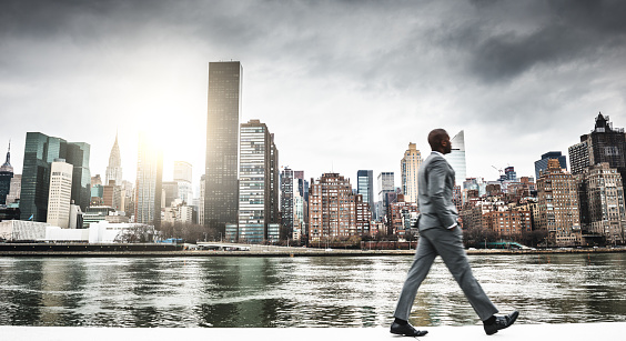 Successful business man looking away against the skyline