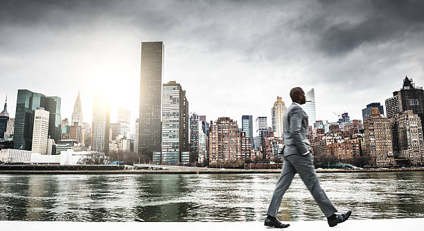 Successful business man looking away against the skyline Successful business man looking away against the skyline rich black men pictures stock pictures, royalty-free photos & images