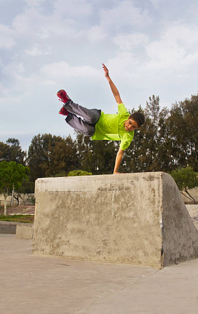 Parkour jump teenager Parkour jump teenager in skate park free running stock pictures, royalty-free photos & images