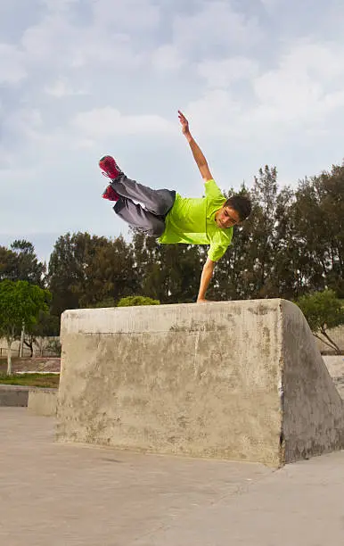 Parkour jump teenager in skate park