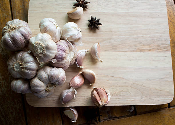 istock Garlic and Pepper with Wood Chopping Block 542548604