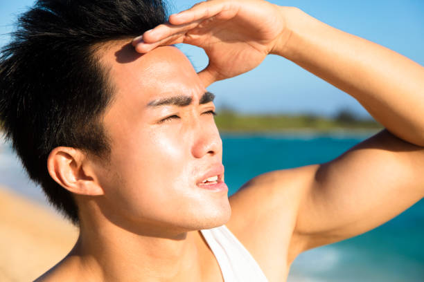 closeup young man face under  summer heat wave
