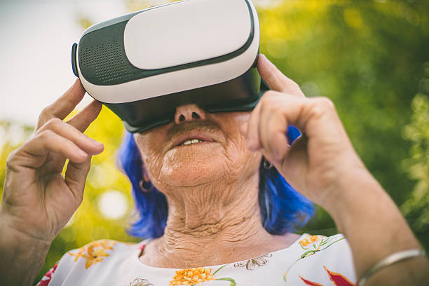 istock Very elderly Woman wearing Virtual Reality Glasses 542549762