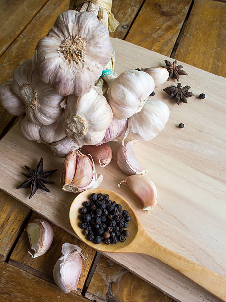 istock Garlic and Black Pepper in wooden spoon 542549906