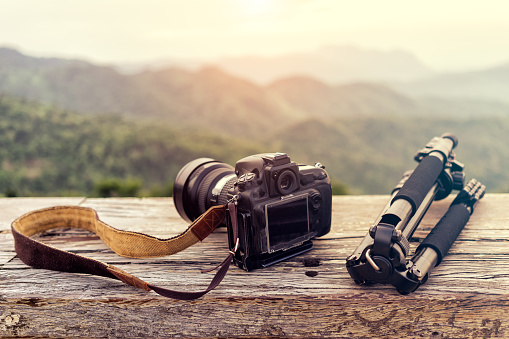 Travel photographer equipment with beautiful landscape on the background, Traveling and Relax Concept.