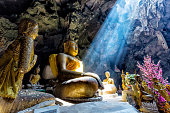 istock Amazing Buddhism with the ray of light in the cave 542551560