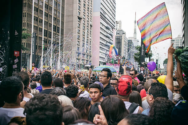 Sao Paulo Gay Pride Parade Sao Paulo, Brazil- May 29, 2016: Large group of people celebrating at the largest gay pride parade in the world. This parade takes place every year on the Paulista Avenue, an important street for buisness and commerce in Sao Paulo. This manifestation reached two million people. sao paulo gay pride parade stock pictures, royalty-free photos & images