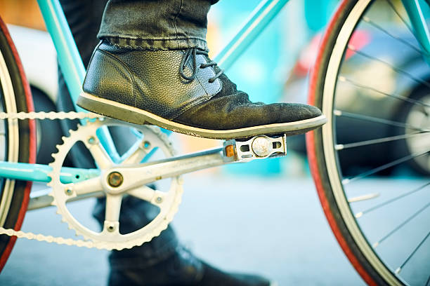 istock Close-up of man's leg on bicycle pedal 542552478