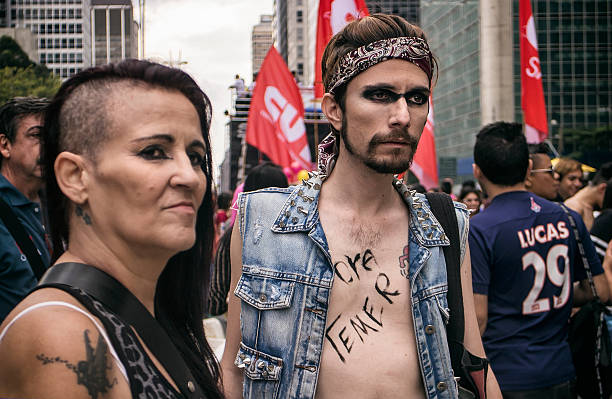 Sao Paulo Gay Pride Parade Sao Paulo, Brazil- May 29, 2016: Two people celebrating at the largest gay pride parade in the world. This parade takes place every year on the Paulista Avenue, an important street for buisness and commerce in Sao Paulo. This manifestation reached two million people. sao paulo gay pride parade stock pictures, royalty-free photos & images