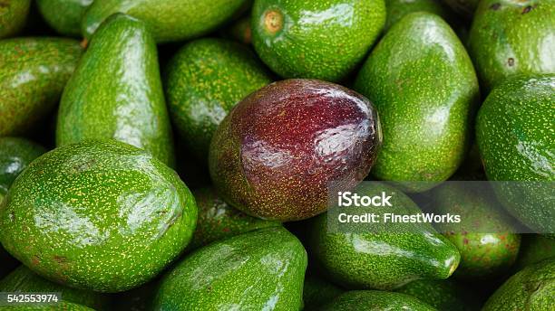 Ripe Red Avocado In Bunch Of Green Avocados Stock Photo - Download Image Now - Avocado, Close-up, Cross Section