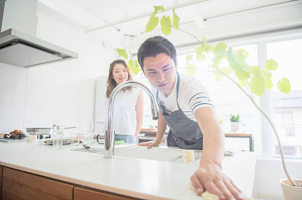 istock Young couple washing dishes together. 542555710