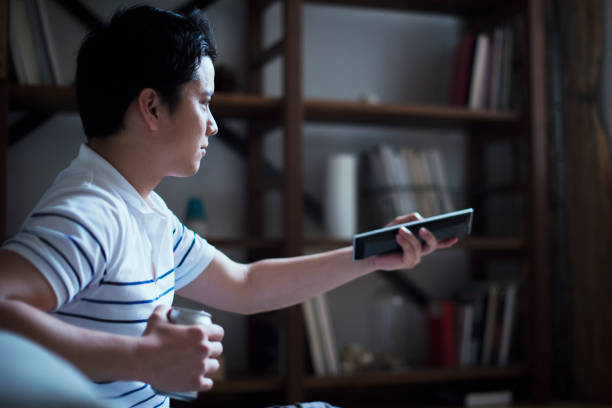 istock Young men watching television at home. 542556622