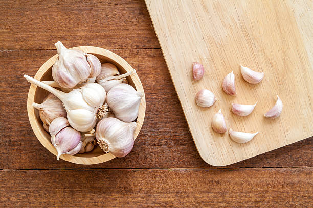 istock Fresh garlic on wood background 542559418
