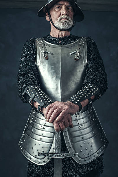 istock Weathered hands of knight holding sword. 542564542
