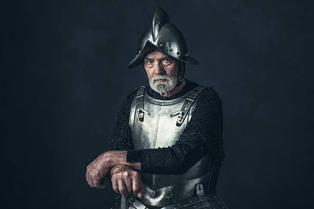istock Senior knight in armor holding sword. 542564718